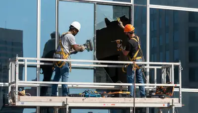 Minneapolis, MN siding contractor repairing a damaged window frame on a home exterior